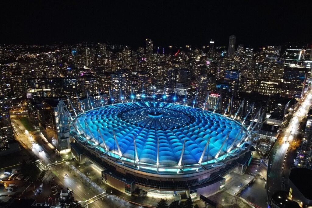 Illuminated BC Place Stadium in Vancouver at night, showcasing stunning cityscape views.